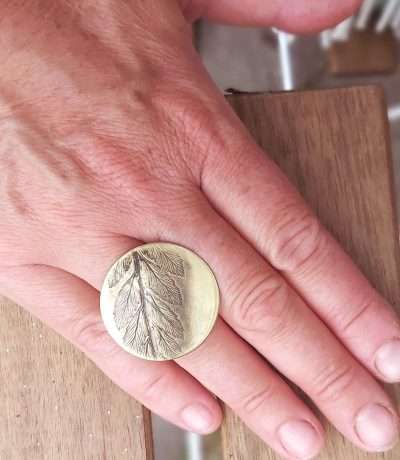 fern brass ring on hand