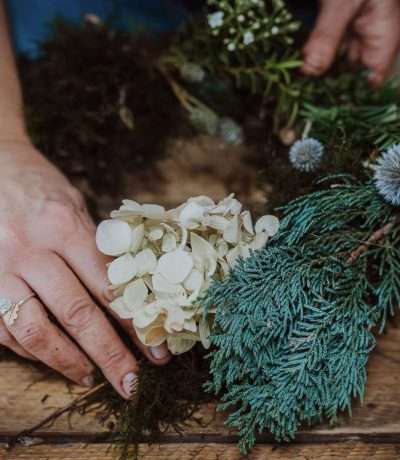 Hands making wild wreath