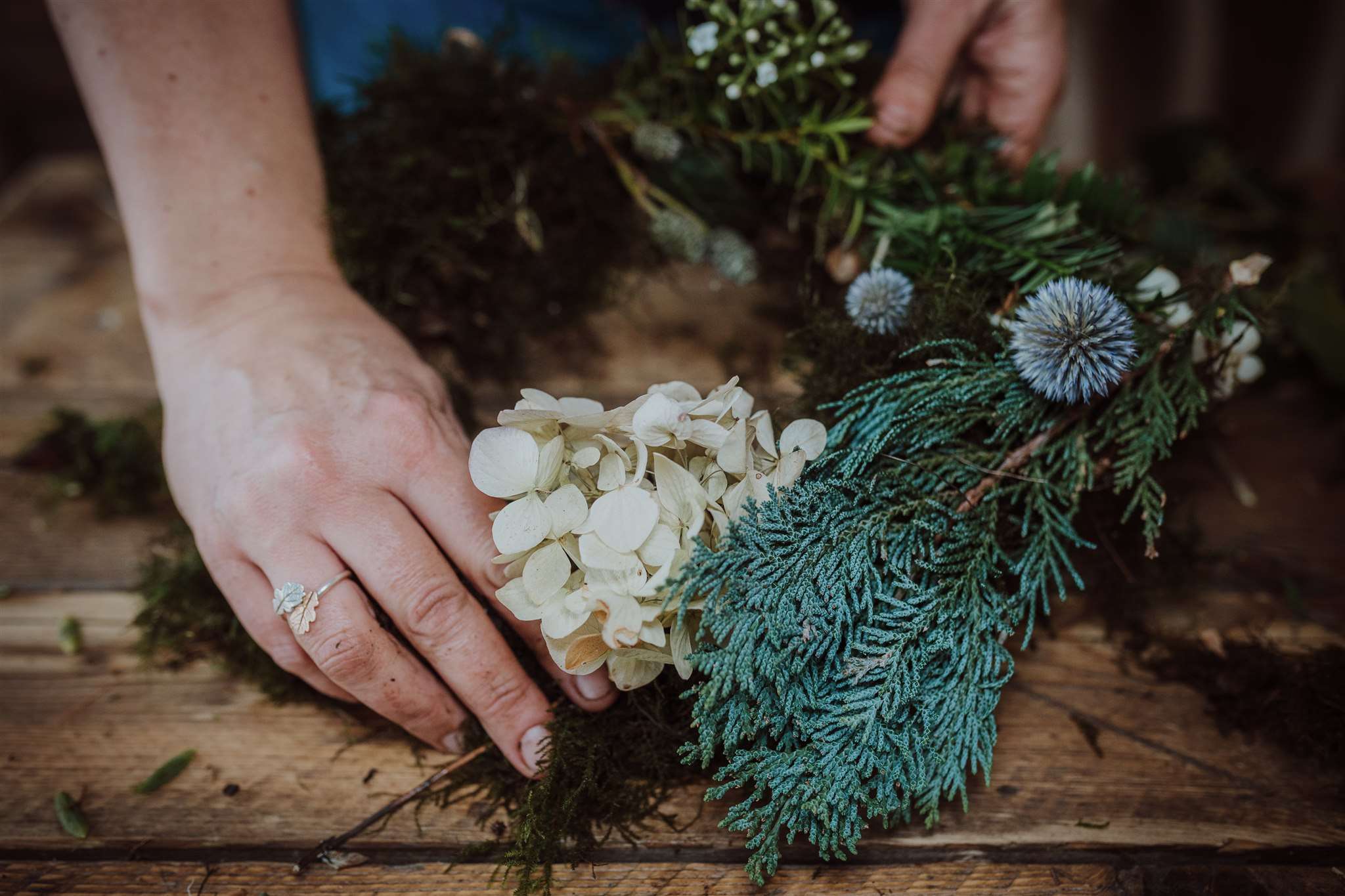 Hands making wild wreath